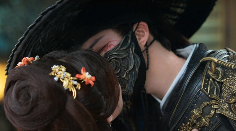 A scene from Chinese period drama, A Dream Within a Dream episodes 20-22 recap of a masked man kissing a woman