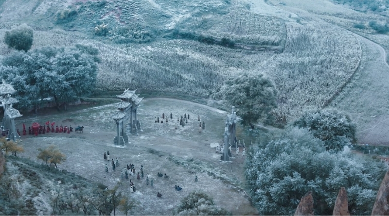 Scene from modern Chinese drama The Road To Splendor Episode 1 recap of an aerial shot of a wedding procession meeting a funeral procession under some arches in the snow