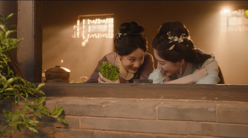 Scene from modern Chinese drama The Road To Splendor Episode 15 recap of 2 women laughing from the window of the kitchen