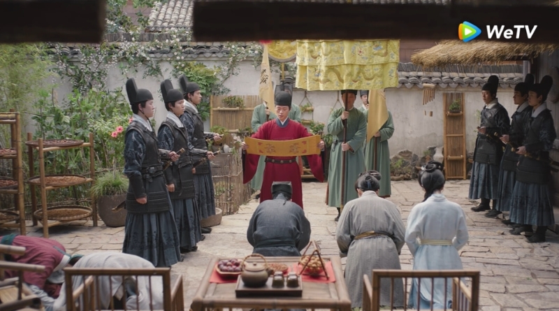 Scene from period Chinese drama Against The Current (2026) Episode 25 Recap and review of an imperial decree being read in a courtyard of a house Infront of a small family