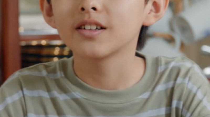 Scene from modern Chinese drama Road Home Episode 24 recap and review of a young boy in a green striped t shirt