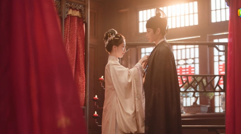 Scene from period Chinese drama The Road To Splendor Episode 26 recap and review of a woman dressing her husband
