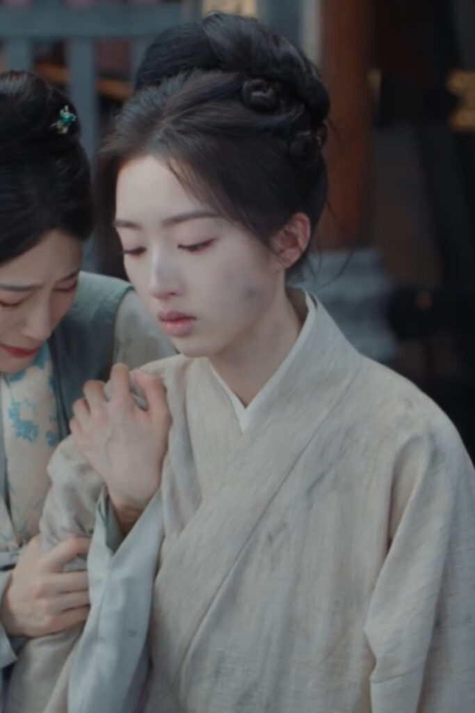 Scene from period Chinese drama The Road To Splendor Episode 34 recap and review of a woman being carried out by her maid, crying and dirty, form prison