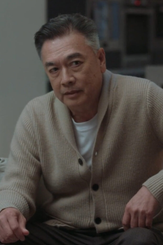 Scene from modern Chinese drama The Early Spring Episode 12 recap and review of a man in a beige cardigan, sitting down