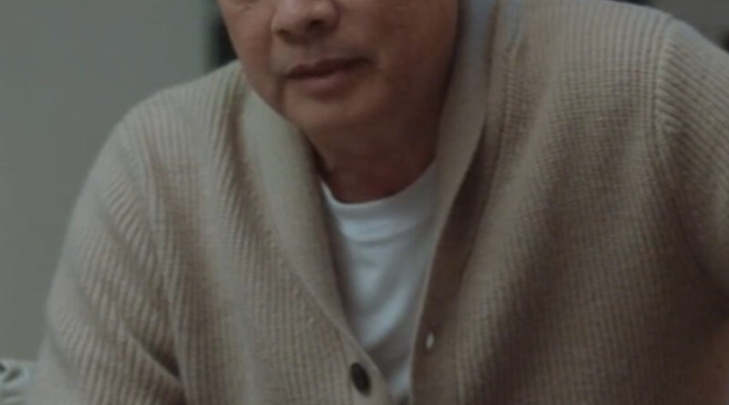 Scene from modern Chinese drama The Early Spring Episode 12 recap and review of a man in a beige cardigan, sitting down
