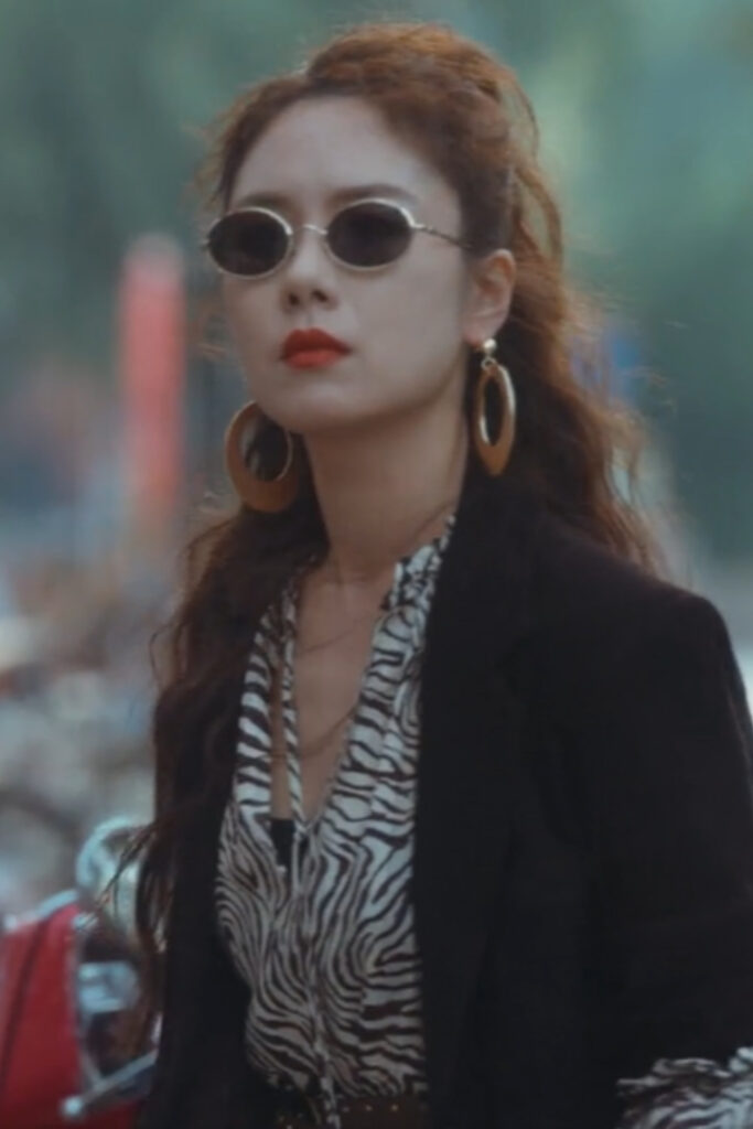 Scene from modern Chinese drama The Early Spring Episode 14 recap and review of a woman in sunglasses looking gangster