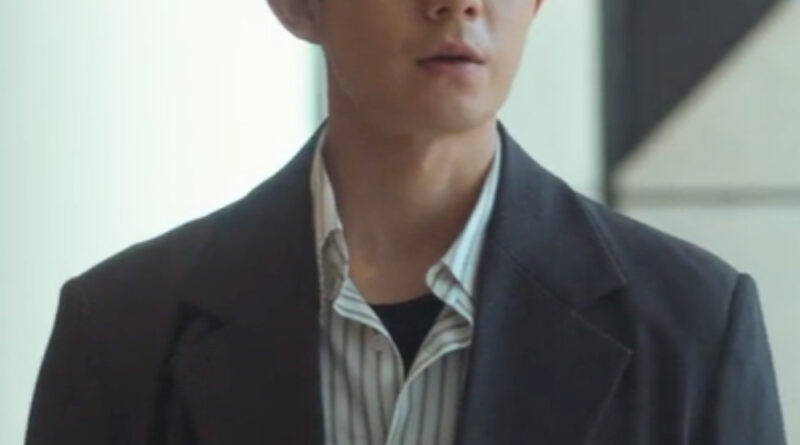 Scene from modern Chinese drama The Early Spring Episode 18 recap and review of a man in a striped shirt and black jacket