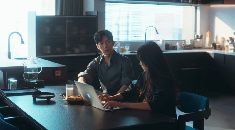Scene from modern Chinese drama The Early Spring Episode 6 recap and review of a man talking to a woman on her laptop while having breakfast