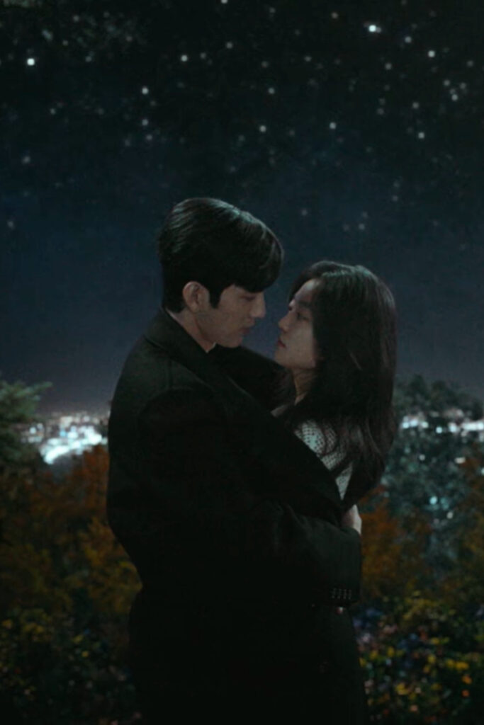 Scene from modern Chinese drama The Early Spring Episode 8 recap and review of couple cuddling on top of a mountain at night with the man wrapping the girl up in his big jacket
