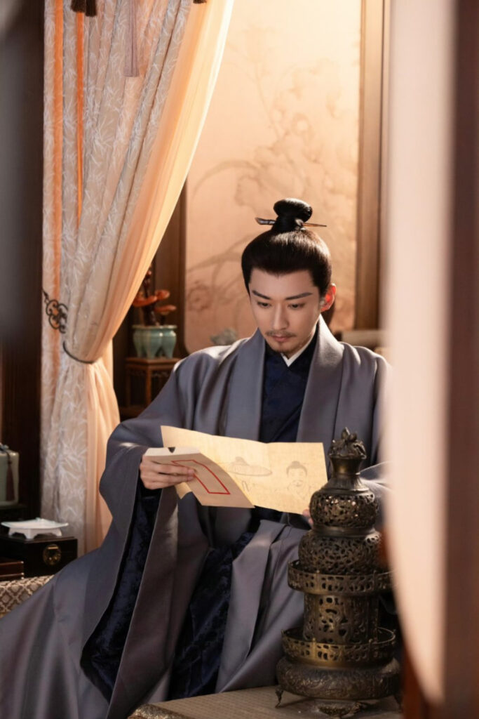 Scene from period Chinese drama Against The Current (2026) Episode 44 Recap and review of a man looking at a letter with paintings of people