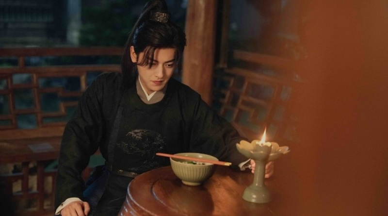 Scene from period Chinese drama Spring of The Blade (2026) Episode 11 Recap and review of a man eating a bowl of noodles at a table