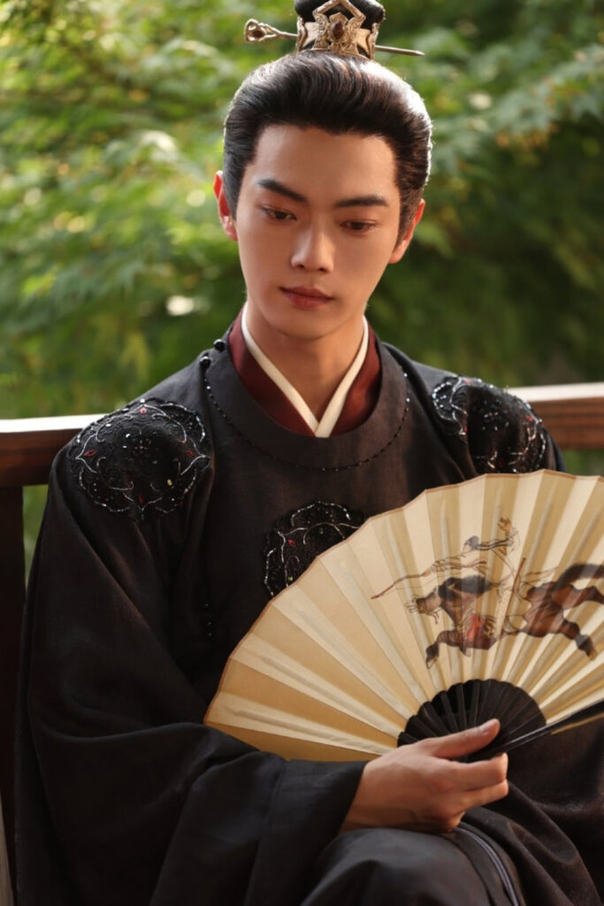 Scene from period Chinese drama Spring of The Blade (2026) Episode 22 Recap and review of a man sitting calmly while fanning himself
