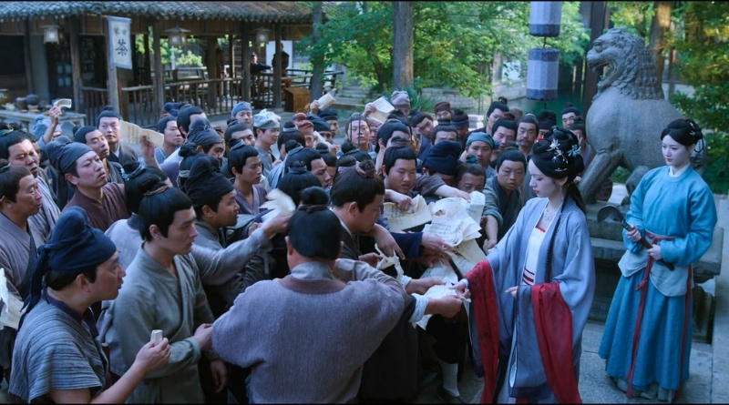 Scene from period Chinese drama Spring of The Blade (2026) Episode 6 Recap and review of a woman putting her thumbprint on contracts in a mass crowd