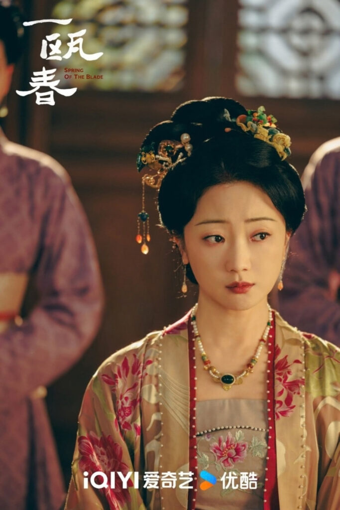 Scene from period Chinese drama Spring of The Blade (2026) Episode 7 Recap and review of a woman not looking happy in a red and gold hanfu