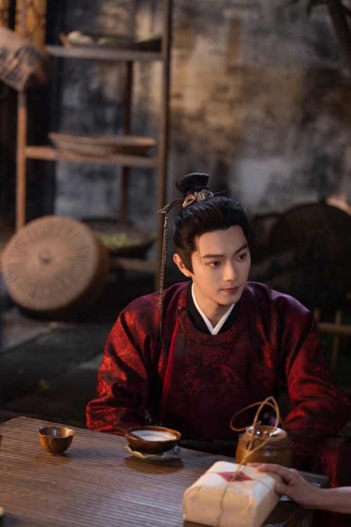 Scene from period Chinese drama Spring of The Blade (2026) Episode 8 Recap and review of a man having dessert in a tea house looking at someone